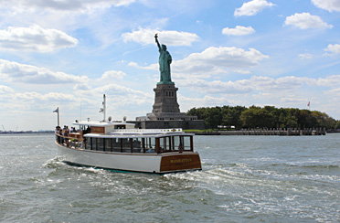 Statue of liberty and the yacht Manhattan in NY Harbor