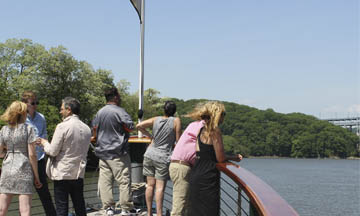 groups of people looking out over a boat, sightseeing